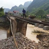 Nền đường sắt bị nước lũ xói mạnh sâu chỉ còn ray và tà vẹt trên tuyến đường sắt Hà Nội-Lạng Sơn ngày 11/5. (Ảnh: TTXVN phát)