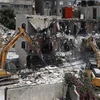 Nhà chức trách Israel phá hủy toà nhà 3 tầng ở khu dân cư Silwan tại Đông Jerusalem, ngày 10/5. (Ảnh: AFP/TTXVN)
