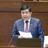 Bộ trưởng Bộ Kế hoạch và Đầu tư Nguyễn Chí Dũng giải trình những vấn đề có liên quan. (Ảnh: Doãn Tấn/TTXVN)
