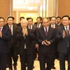 Tổng Bí thư Nguyễn Phú Trọng cùng các vị lãnh đạo Đảng, Nhà nước và đại biểu đến dự hội nghị. (Ảnh: Trí Dũng/TTXVN)