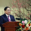 Thủ tướng Phạm Minh Chính chúc Tết ngành ngân hàng. (Ảnh: Dương Giang/TTXVN)