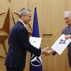 Tổng Thư ký NATO Jens Stoltenberg (trái) tiếp nhận đơn xin gia nhập liên minh quân sự từ đại sứ Thụy Điển tại NATO Axel Wernhoff ở Brussels (Bỉ), ngày 18/5/2022. (Ảnh: AFP/TTXVN)