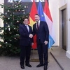 Thủ tướng Chính phủ Phạm Minh Chính và Thủ tướng Luxembourg Xavier Bettel. (Ảnh: Dương Giang/TTXVN)
