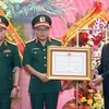 Chủ tịch nước Võ Văn Thưởng trao tặng Huân chương Chiến công hạng Nhất cho Tổng Cục II, Bộ Quốc phòng. (Ảnh: Thống Nhất/TTXVN)