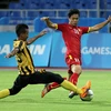 U23 Malaysia (áo vàng đen) đối mặt nguy cơ bị loại sớm. (Ảnh: Quốc Khánh/TTXVN)