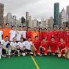 Tổng Lãnh sự Trần Thanh Huân (áo vàng đứng giữa) chụp ảnh lưu niệm với các cầu thủ. (Ảnh: PV/Vietnam+)