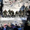 Nhân viên cứu hộ tìm kiếm nạn nhân dưới những đống đổ nát sau trận động đất ở Thumane, Albania. (Ảnh: AFP/TTXVN)