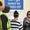 Người dân xếp hàng chờ xét nghiệm nhanh COVID-19 tại bãi biển Bondi ở Sydney, Australia. (Ảnh: AFP/TTXVN)