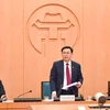 Bí thư Thành ủy Hà Nội Vương Đình Huệ chỉ đạo triển khai các biện pháp cấp bách đối phó với diễn biến mới của dịch COVID-19. (Ảnh: Vietnam+)