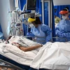 Nhân viên y tế điều trị cho bệnh nhân COVID-19 tại bệnh viện ở Cambridge, Anh. (Ảnh: AFP/TTXVN)