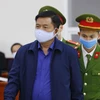 Cảnh sát dẫn giải bị cáo Đinh La Thăng vào phiên tòa xét xử. (Ảnh: Doãn Tấn/TTXVN)