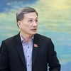 Chủ nhiệm Ủy ban Khoa học Công nghệ Môi trường của Quốc hội Lê Quang Huy trình bày báo cáo. (Ảnh: Doãn Tấn/TTXVN)
