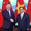 Thủ tướng Phạm Minh Chính và Tổng Bí thư, Chủ tịch nước Trung Quốc Tập Cận Bình chụp ảnh chung. (Ảnh: Dương Giang/TTXVN)
