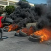 Người biểu tình gây bạo loạn tại Port-au-Prince, Haiti sau quyết định từ chức của Thủ tướng Ariel Henry, ngày 12/3. (Ảnh: AFP/TTXVN)