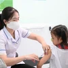 Y, bác sỹ tiêm vaccine sởi cho học sinh tiểu học. (Ảnh: Thanh Bình/TTXVN)