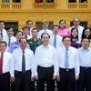 Chủ tịch nước Trần Đại Quang với các đồng chí lãnh đạo của Tòa án Nhân dân Tối cao. (Ảnh: Nhan Sáng/TTXVN)