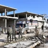 Lực lượng ủng hộ Chính phủ Syria sau khi giành lại quyền kiểm soát quận Myessar, phía đông Aleppo ngày 4/12. (Nguồn: AFP/TTXVN)