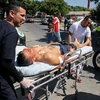 Chuyển một cảnh sát bị thương tại hiện trường vụ tấn công ở Barranquilla, Colombia ngày 27/1. (Nguồn: AFP/TTXVN)