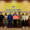 Ban huấn luyện các cầu thủ đội tuyển bóng đá nữ Việt Nam nhận phần quà 1 năm bay miễn phí từ hãng hàng không Vietjet. (Ảnh: CTV/Vietnam+)