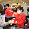 Hành khách làm thủ tục lên chuyến bay của hãng hàng không Vietjet. (Ảnh: CTV/Vietnam+)