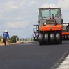 Nhà thầu thi công thảm bê tông nhựa nền đường cao tốc. (Ảnh: Việt Hùng/Vietnam+)