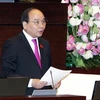 Phó Thủ tướng Nguyễn Xuân Phúc trả lời chất vấn của các đại biểu Quốc hội. (Ảnh: Nguyễn Dân/TTXVN)
