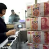 Giao dịch tại một ngân hàng ở thành phố Liên Vận Cảng, tỉnh Giang Tô, Trung Quốc ngày 7/1. (Nguồn: AFP/TTXVN)