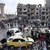 Hiện trường vụ đánh bom kép ở Al-Zahraa, thành phố Homs, Syria ngày 21/2. (Nguồn: AFP/TTXVN)