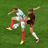 Tiền đạo Harry Kane (trái) đội tuyển Anh tranh bóng quyết liệt với hậu vệ Vasily Berezutskiy (đội tuyển Nga). (Nguồn: AFP/TTXVN)