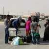 Thường dân người Kurd ở Hasaka sơ tán tới thành phố Qameshli để lánh chiến sự. (Nguồn: AFPTTXVN)