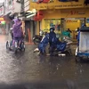 Nước ngập các đường Hùng Vương và Nguyễn Tri Phương, thành phố Huế. (Ảnh: Quốc Việt/TTXVN)