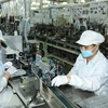 Sản xuất linh kiện điện tử kỹ thuật cao tại Cty TNHH Nidec Sankyo Việt Nam (Nhật Bản) trong Khu Công nghệ cao TP.Hồ Chí Minh. (Ảnh: Thanh Vũ/TTXVN)