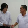 Chủ tịch Ủy ban Mặt trận Tổ quốc Đồng Nai nhờ TTXVN chuyển quà hỗ trợ cho gia đình nhà báo Đinh Hữu Dư. (Ảnh: Vietnam+)