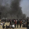 Xung đột giữa người biểu tình Palestine với binh sỹ Israel tại khu vực biên giới Dải Gaza-Israel ngày 14/5. (Nguồn: THX/TTXVN)