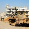 Binh sỹ Syria tiến vào giải phóng thị trấn Nuaimeh, gần cửa khẩu Nasib ngày 6/7. (Nguồn: THX/TTXVN)