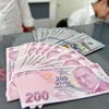 Đồng Lira của Thổ Nhĩ Kỳ (phía trước) và đồng USD tại quầy giao dịch tiền tệ ở Ankara, Thổ Nhĩ Kỳ ngày 10/8. (Ảnh: THX/TTXVN)