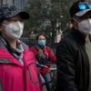 Người dân đeo khẩu trang để tránh tác hại của ô nhiễm không khí tại Bắc Kinh, Trung Quốc ngày 22/10/2018. (Ảnh: AFP/TTXVN)