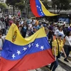 Hàng trăm nghìn người biểu tình trên các đường phố ở thủ đô Caracas ngày 23/1. (Nguồn: AFP)