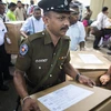 Cảnh sát và các quan chức bầu cử làm nhiệm vụ tại thủ đô Colombo, Sri Lanka ngày 15/11/2019. (Ảnh: AFP/TTXVN)