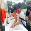 Học sinh Trường mầm non Ỷ La, thành phố Tuyên Quang rửa tay bằng xà phòng trước khi vào lớp. (Ảnh: Quang Cường/TTXVN)