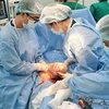 Các bác sỹ Bệnh viện Hùng Vương và Bệnh viện Nhi đồng Thành phố phối hợp phẫu thuật lấy thai an toàn cho bệnh nhi. (Ảnh: TTXVN)