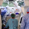 Nhân viên y tế chuyển bệnh nhân nhiễm COVID-19 tới bệnh viện ở Milan, Italy. (Ảnh: AFP/TTXVN)