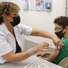 Nhân viên y tế tiêm vaccine ngừa COVID-19 của hãng Pfizer-BioNTech cho trẻ 12 tuổi tại Tel Aviv, Israel ngày 6/6/2021. (Ảnh: AFP/TTXVN)