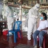 Lực lượng y tế tỉnh Quảng Bình và các đơn vị, lực lượng chức năng tỉnh Khăm Muộn (Lào) tiến hành lấy mẫu xét nghiệm trong cộng đồng. (Ảnh: TTXVN phát)
