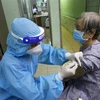 Các y bác sỹ tiêm vaccine cho người trên 65 tuổi, người có bệnh nền tại Trung tâm y tế phường 11, quận Phú Nhuận. (Ảnh: Thanh Vũ - TTXVN)