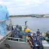 Đưa ngư dân bị nạn lên bờ tại thành phố Vũng Tàu. (Ảnh: TTXVN phát)