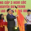 Chủ tịch Quốc hội Vương Đình Huệ trao Huân chương lao động hạng Nhất lần thứ 2 cho Trường THPT Nguyễn Duy Trinh. (Ảnh: Bích Huệ/TTXVN)