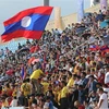 Cổ động viên trên khán đài nhiệt tình cổ vũ cho đội U23 Lào. (Ảnh: Thanh Tùng/TTXVN)