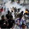 Cảnh sát bắn hơi cay trong cuộc biểu tình yêu cầu Thủ tướng Haiti Ariel Henry từ chức ngày 10/10. (Nguồn: Reuters)