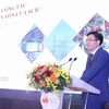 Phó Tổng Giám đốc SCIC Lê Thanh Tuấn báo cáo tại Hội nghị. (Ảnh: VGP)
